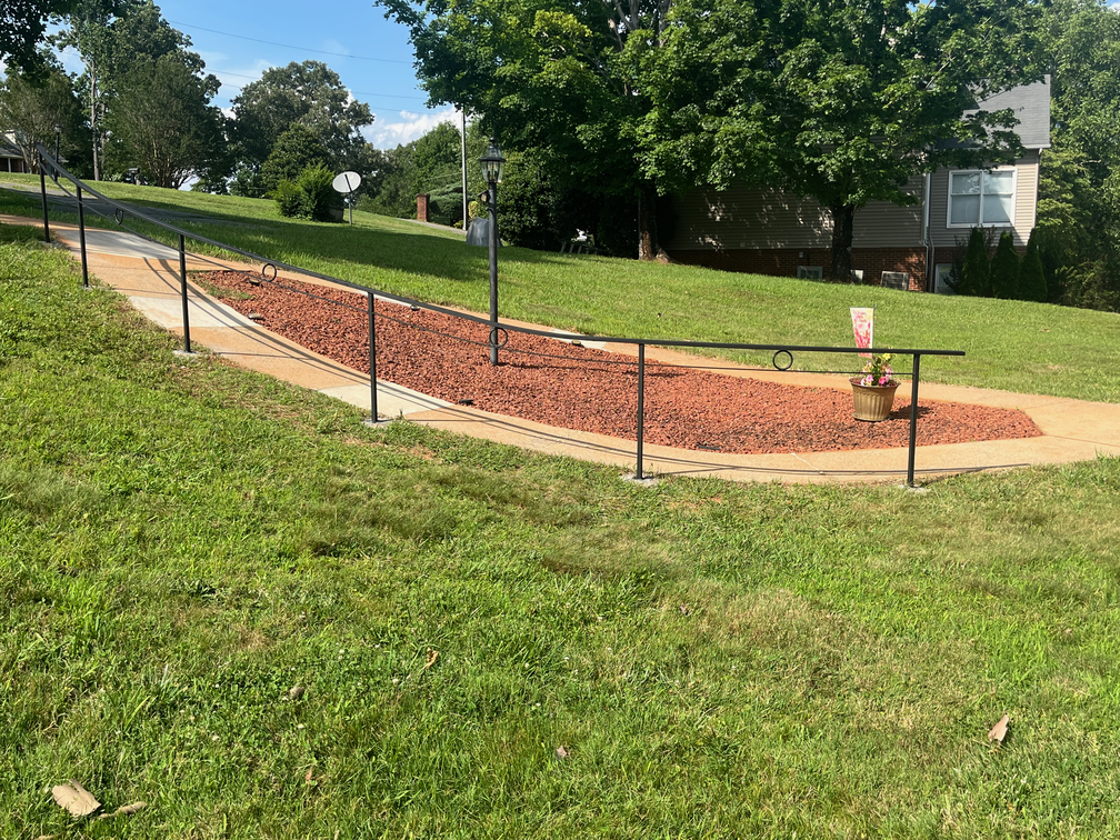Modern handrail long sloping and curving path.